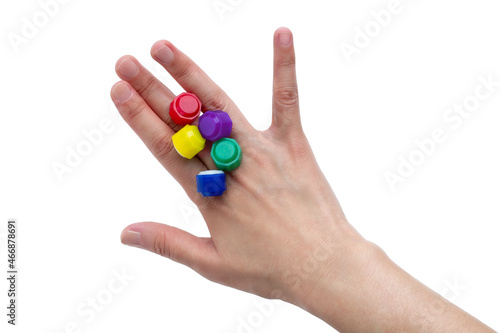 Korean traditional game kit Gonggi. Colourful plastic stones on the back of the player's hand. Isolated on white background. 
 photo