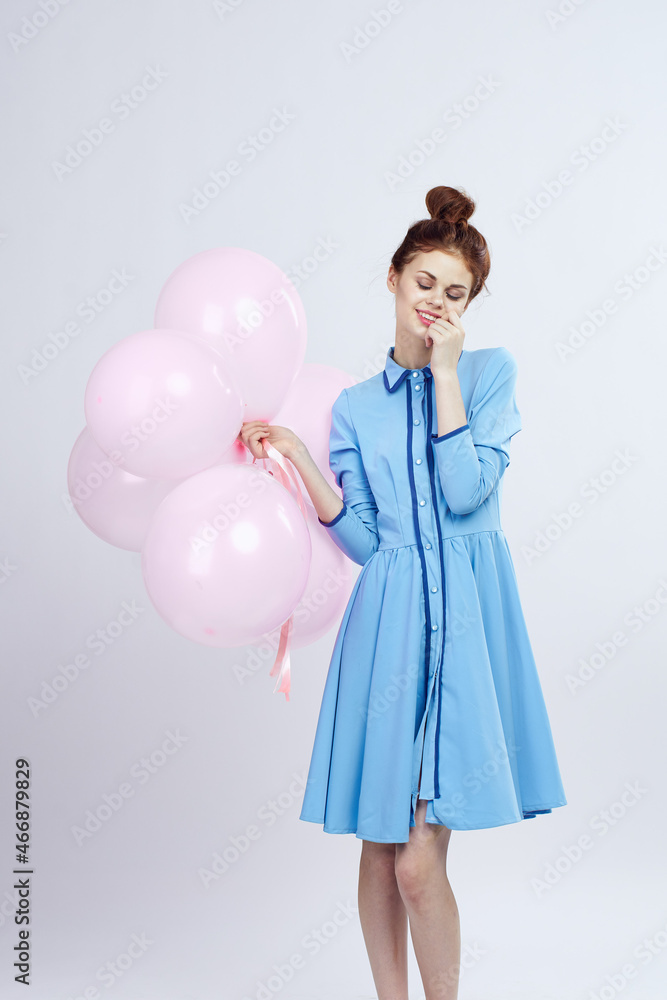 cheerful woman in a blue dress pink balloons holiday birthday cheerful woman in a blue dress pink balloons holiday birthday