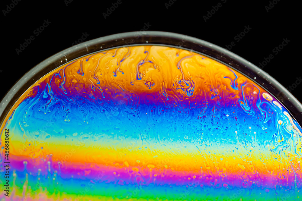 Obraz premium macro of soap bubbles made with dish soap on black background detergent bubbles. Imitation of an unknown planet. Children's entertainment. Science fiction. macro of soap bubbles like Planet, ocean wav