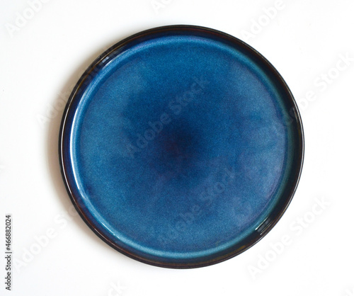 Canvas Print round blue handmade ceramic plate isolated on a white background
