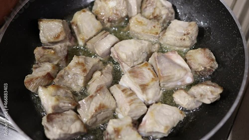 Cooking pork ribs in a frying pan. Rice Preparation