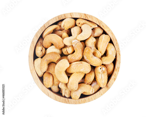 Big pile of cashew nuts in wooden bowl isolated on white background.