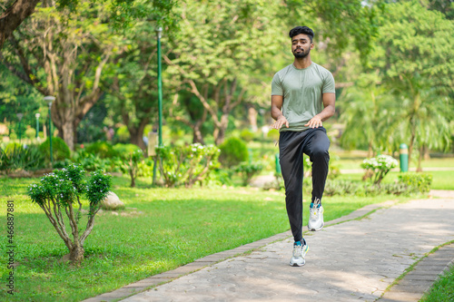 Indian man running on the spot in the park  warming up