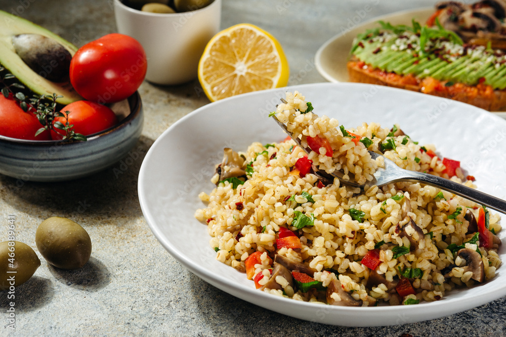 vegetarian and vegan dish bulgur tabbouleh with pepper and herbs vegetarian and vegan dish bulgur tabbouleh with pepper and herbs