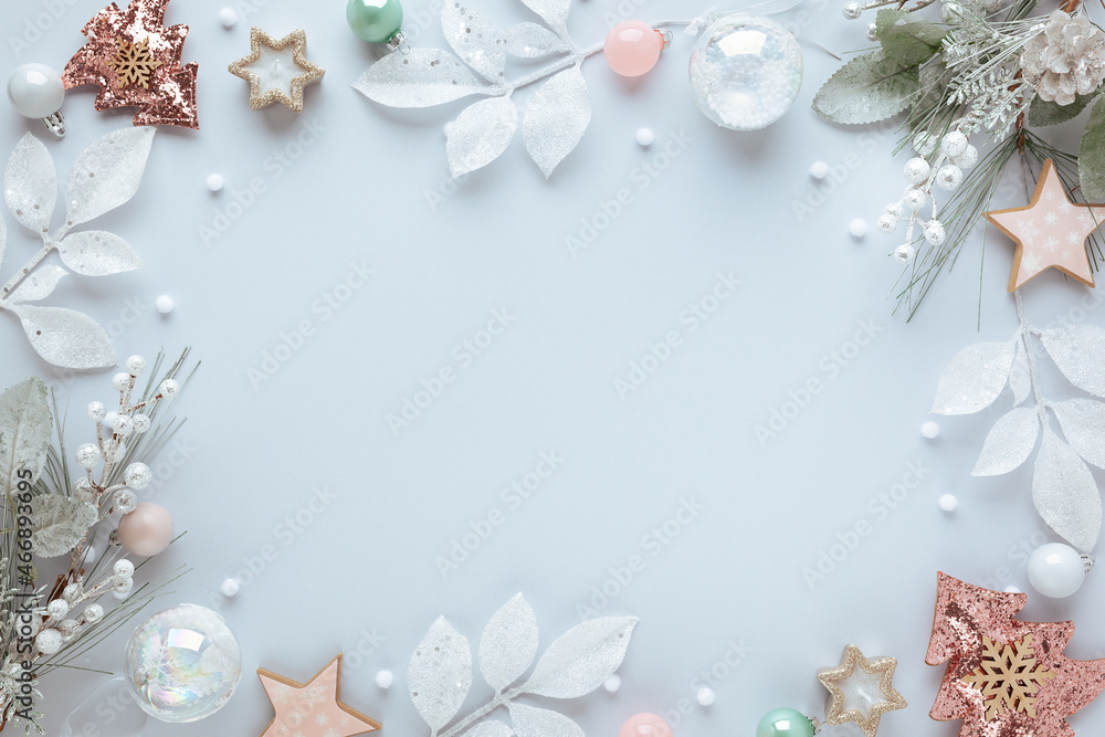 Christmas and New Year holidays frame. Christmas ornaments on light pastel background. Flat lay, copy space. Christmas and New Year holidays frame. Christmas ornaments on light pastel background. Flat lay, copy space.