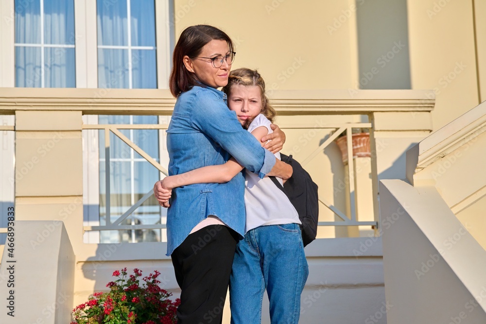 Mom and her daughter, a schoolgirl, are on the doorstep Mom and her daughter, a schoolgirl, are on the doorstep