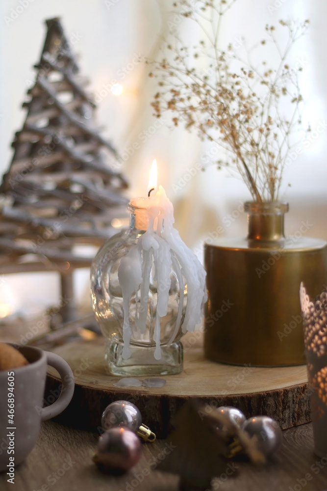 Bowl of cinnamon cookies, lit candles and various Christmas decorations on the table. Selective focus. Bowl of cinnamon cookies, lit candles and various Christmas decorations on the table. Selective focus.
