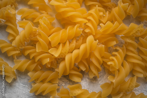 Yellow fusilli pasta on the background. Italian food.