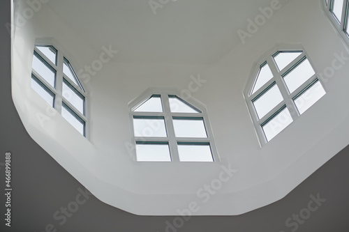 Three windows inside the church under the ceiling