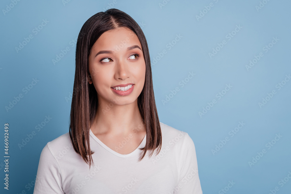 Portrait of young attractive dreamy curious girl happy positive smile look copyspace think isolated on blue color background Portrait of young attractive dreamy curious girl happy positive smile look copyspace think isolated on blue color background