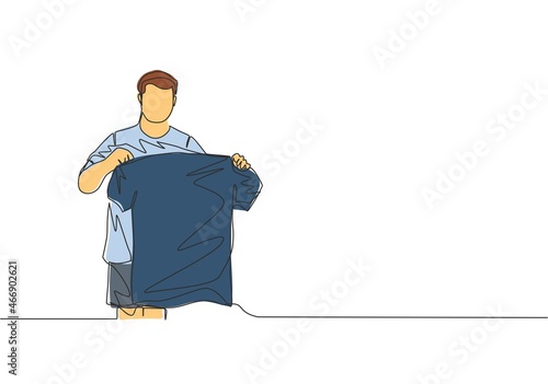 One continuous line drawing of young rising football star holding his new jersey while introduced at press conference. Soccer match sports concept. Single line draw design vector illustration
