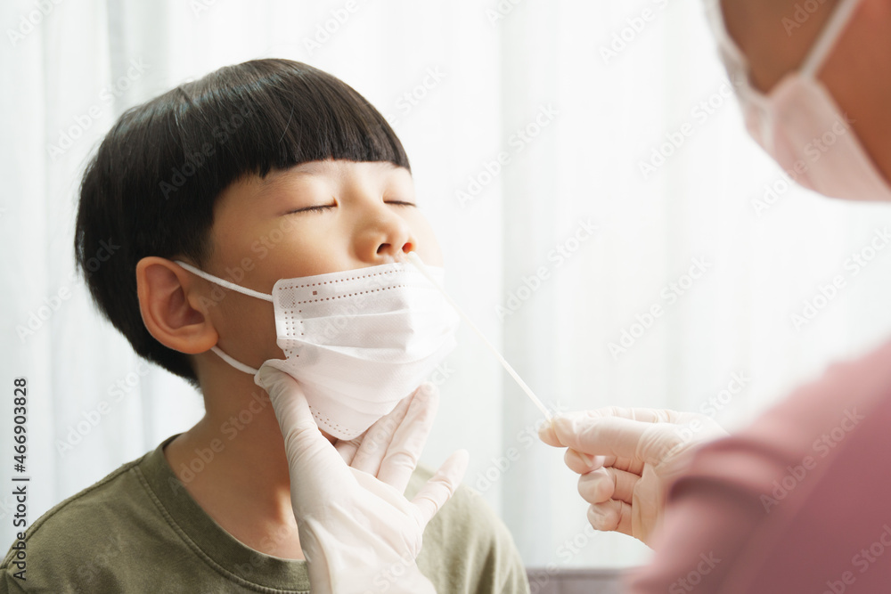 Covid 19 testing before back to school. An asian mom gently do a nose swab rapid test for her little boy at home. Living with Covid, Delta, Mu, New normal, Student, Kids, Small, How to, Tested, Reopen