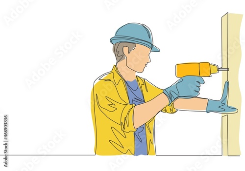 One continuous line drawing of young handsome handyman drilling wooden wall using drill machine. House maintenance service concept single line draw design illustration