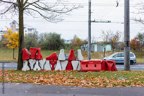 Red and white plastic road barriers. Construction props.