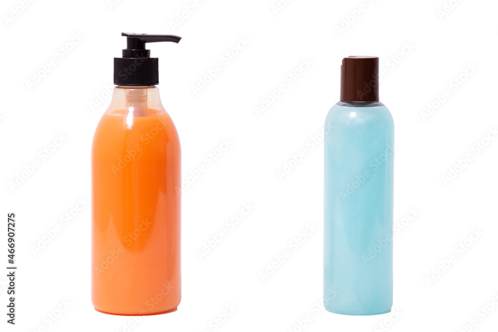 two plastic bottles with brown cap and dispenser with blue pearl and orange shower gel inside on white background isolated two plastic bottles with brown cap and dispenser with blue pearl and orange shower gel inside on white background isolated