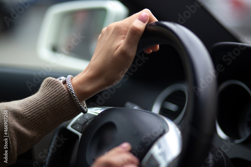 woman's hands on the steering wheel in the car
