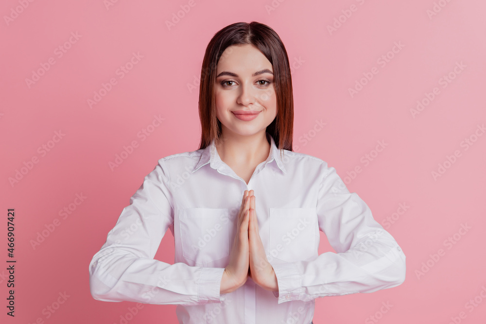 Photo of young pretty lady hold hands together ask wish dream wait expect present pray isolated over pink color background Photo of young pretty lady hold hands together ask wish dream wait expect present pray isolated over pink color background