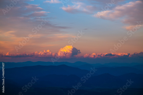Gorgeous sunset with cloudy sky in the mountains.