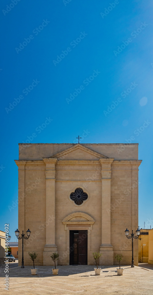 The small village of Acaya, Lecce, Salento, Puglia, Italy. The church of Santa Maria della Neve, in baroque, neoclassical and Romanesque style. The facade in the small square paved in flat stone.