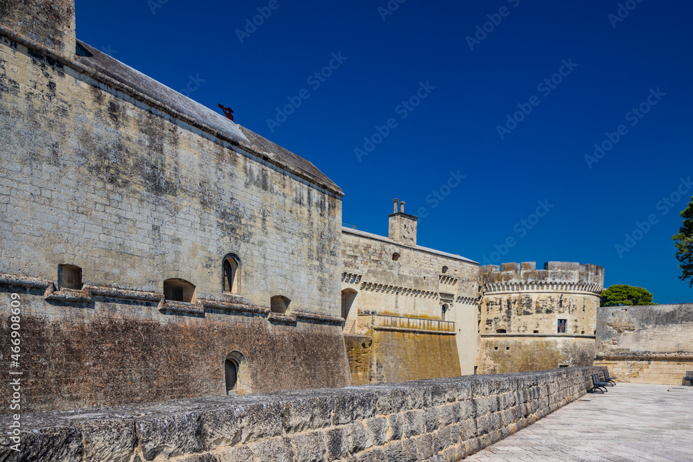 The small fortified village of Acaya, Lecce, Salento, Puglia, Italy. The large stone-paved square. The ancient medieval castle with towers and moat.