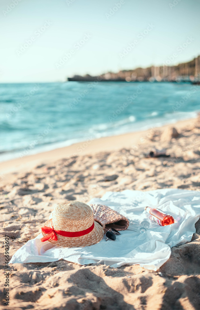 Straw hat, bag, sunglasses and bedspread on a tropical beach. Summer vacation. Straw hat, bag, sunglasses and bedspread on a tropical beach. Summer vacation.