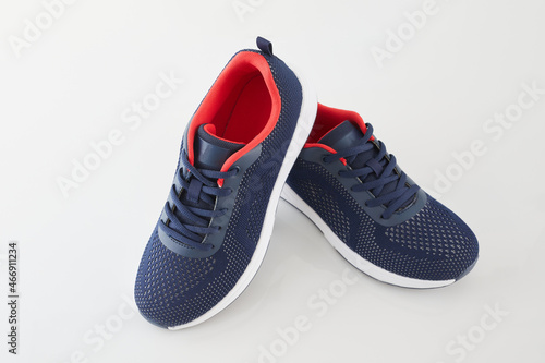 Pair of new unbranded blue running shoes or sneakers isolated on white background. Fashion sport footwear or trainers for fitness.