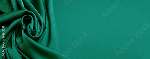 Green silk fabric as background, top view with space for text. Banner design