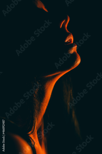 Body aesthetics of a girl on a black background. Emphasis on the girl s neck and natural lips. You can insert text. Hair green. Looks like a still from a movie