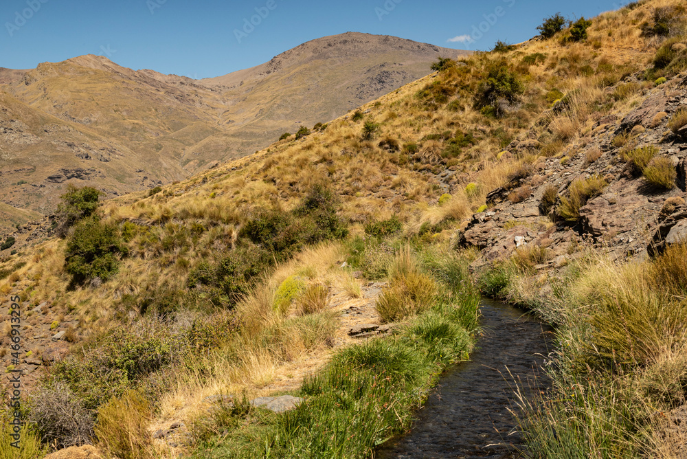 One of the ancient water channel (Acequias) of the Poqueira valley, Las Alpujarras, Sierra Nevada National Park, Andalusia, Spain One of the ancient water channel (Acequias) of the Poqueira valley, Las Alpujarras, Sierra Nevada National Park, Andalusia, Spain