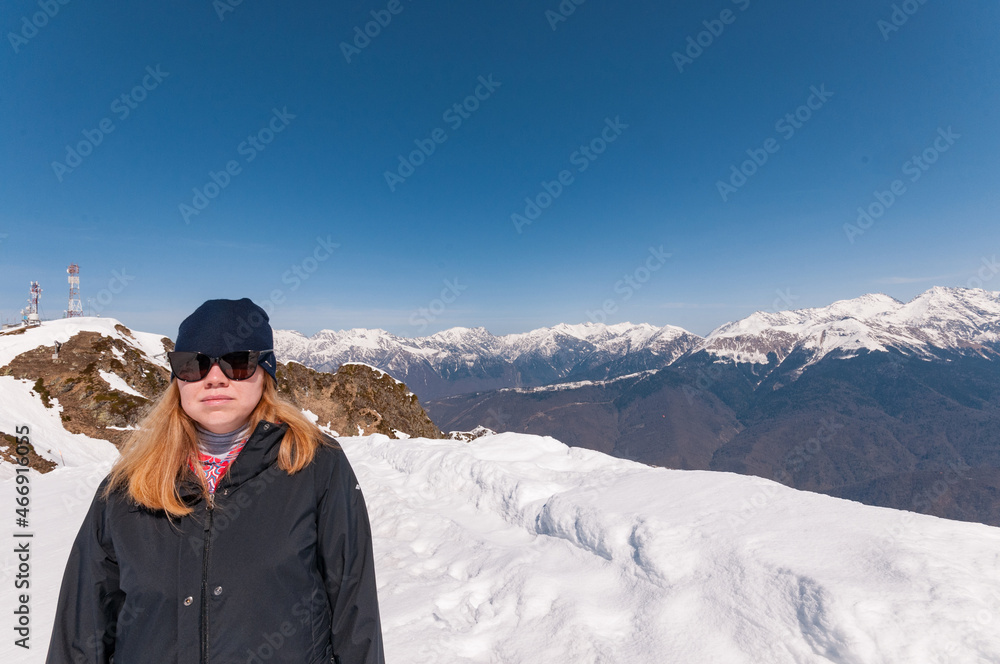 redhead girl in snowy mountains