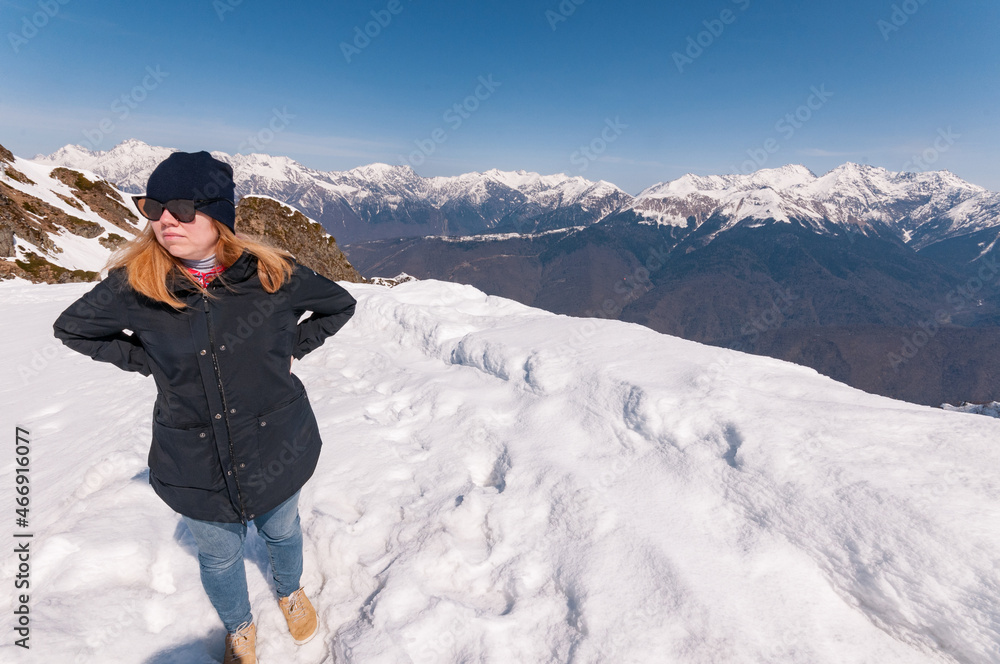 redhead girl in snowy mountains