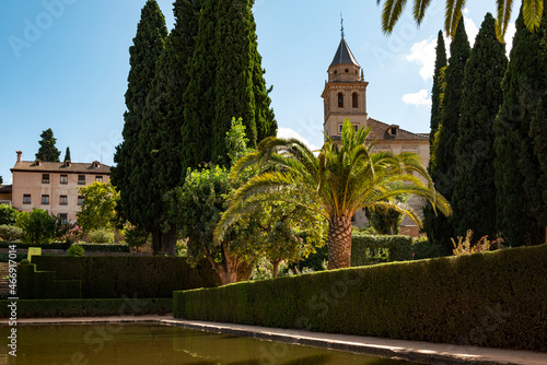 View  over the pool at the Ladies Tower (Torre de las Damas, Partal Palace) towards the Garden of the Partal (Jardines del Partal), Nasrid palaces, Alhambra de Granada, Andalusia, Spain