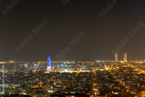 landscape of Barcelona city at night with view of landmarks. night scape and cityscape of the catalan city with city lights and light pollution with view over Montjuic hill