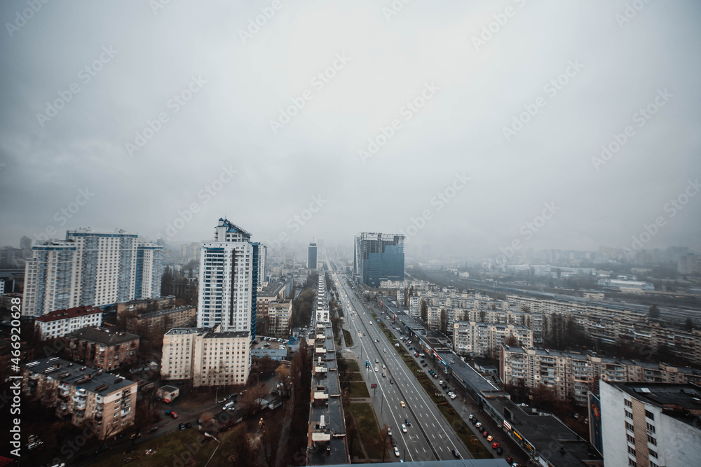 High angle view of the city in blue twilight. Dramatic dark thundercloud, rain clouds cover the city. View of the city of Kiev. Ukraine. Abstract. Blurring.