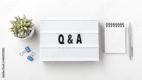 фотографія Q and A concept on lightbox with notebook and pen
