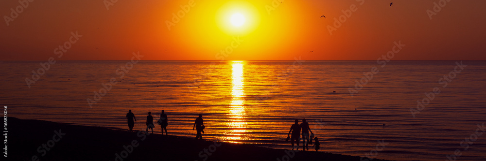 warm orange sunset on the beach panorama