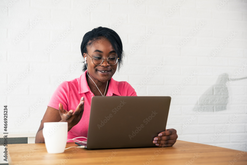 Young happy satisfied expert African American freelancer business woman having funny and relaxing conversation with client over video call on her laptop, business concept Young happy satisfied expert African American freelancer business woman having funny and relaxing conversation with client over video call on her laptop, business concept