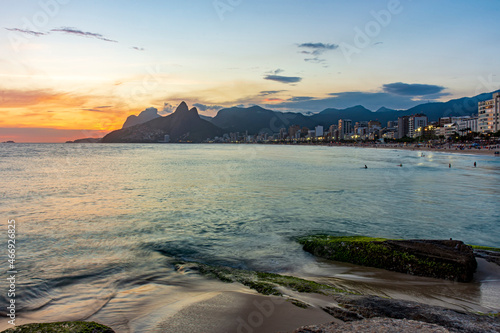 Beautiful sunset behind the mountains of the city of Rio de Janeiro on Ipanema beach
