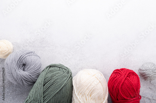 Clews of wool on stone background. Place for your text. Top view