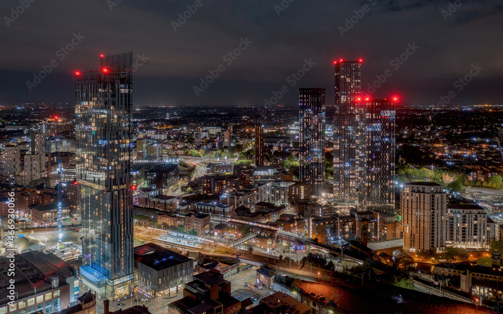 Deansgate Square and Manchester England, modern tower block skyscrapers dominating the Manchester city centre landscape taken at night,. Aerial view of the city lights