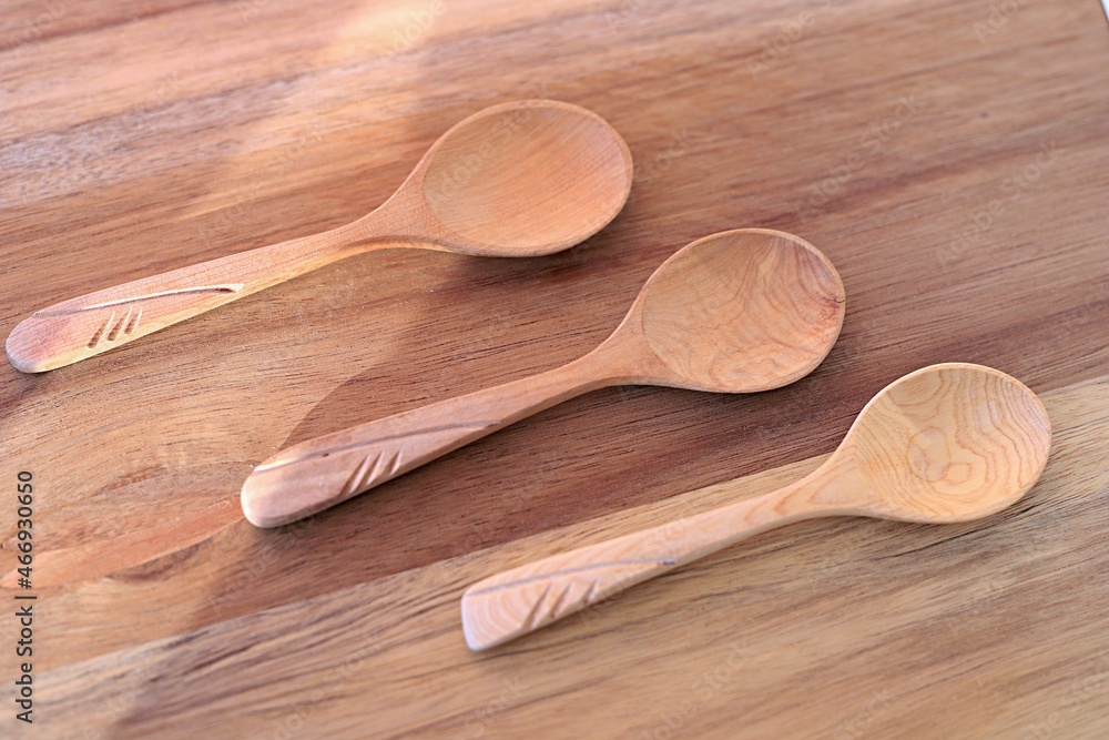 three empty wooden spoons on a wooden cutting board. template for a culinary recipe. cooking. healthy eating three empty wooden spoons on a wooden cutting board. template for a culinary recipe. cooking. healthy eating