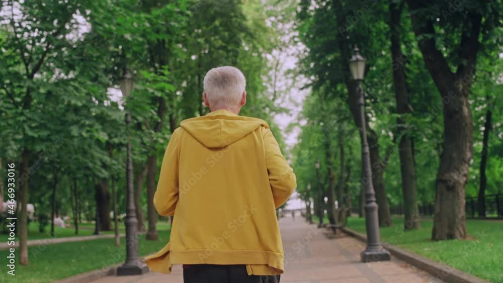 Healthy senior man in sports wear running in park in the morning, lifestyle Healthy senior man in sports wear running in park in the morning, lifestyle