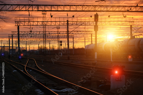 Bright evening sunset at railway station.