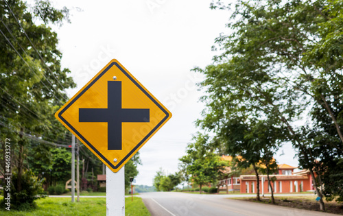 four intersection yellow traffic sign with soft-focus and overlight in the background