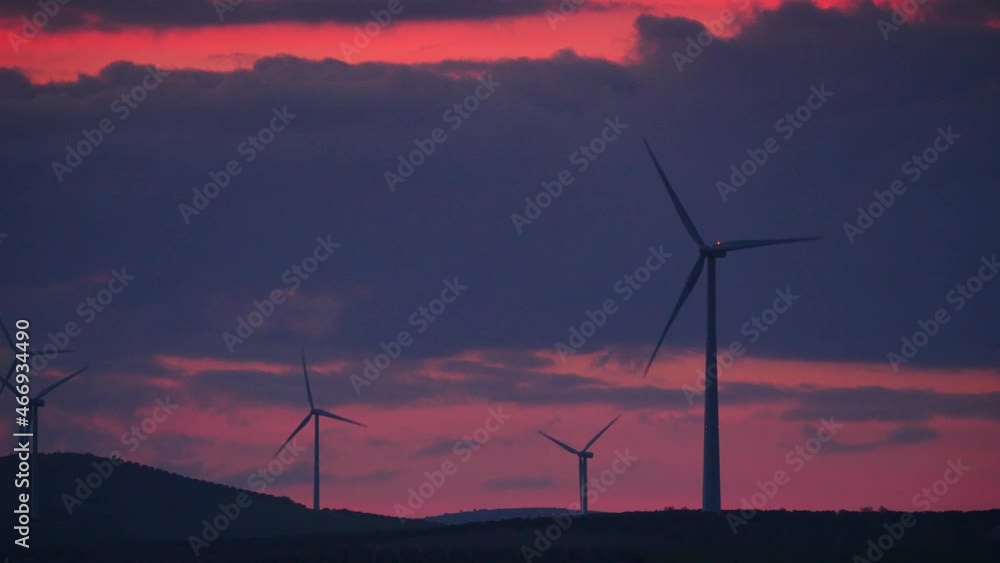 Wind turbines on hills at sunset. Power generator farm for renewable electric energy production near Ardales, province Malaga, Andalusia Spain. Wind turbines on hills at sunset. Power generator farm for renewable electric energy production near Ardales, province Malaga, Andalusia Spain.
