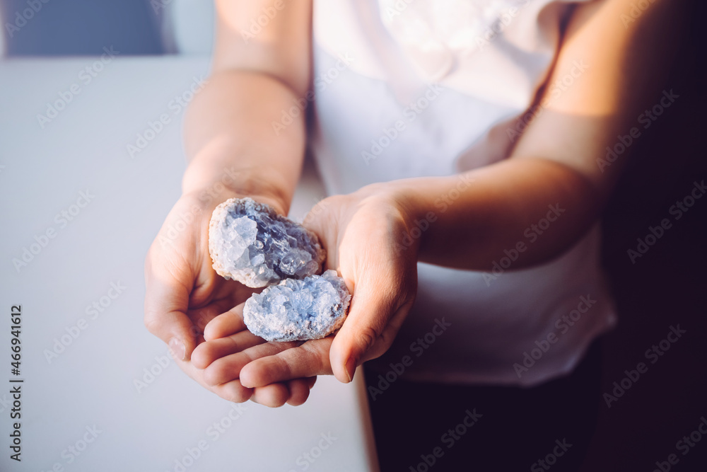 Young 7 year old girl child holding clusters of blue crystals called Celestite. An Indigo Child concept, New Age Term. Young 7 year old girl child holding clusters of blue crystals called Celestite. An Indigo Child concept, New Age Term.