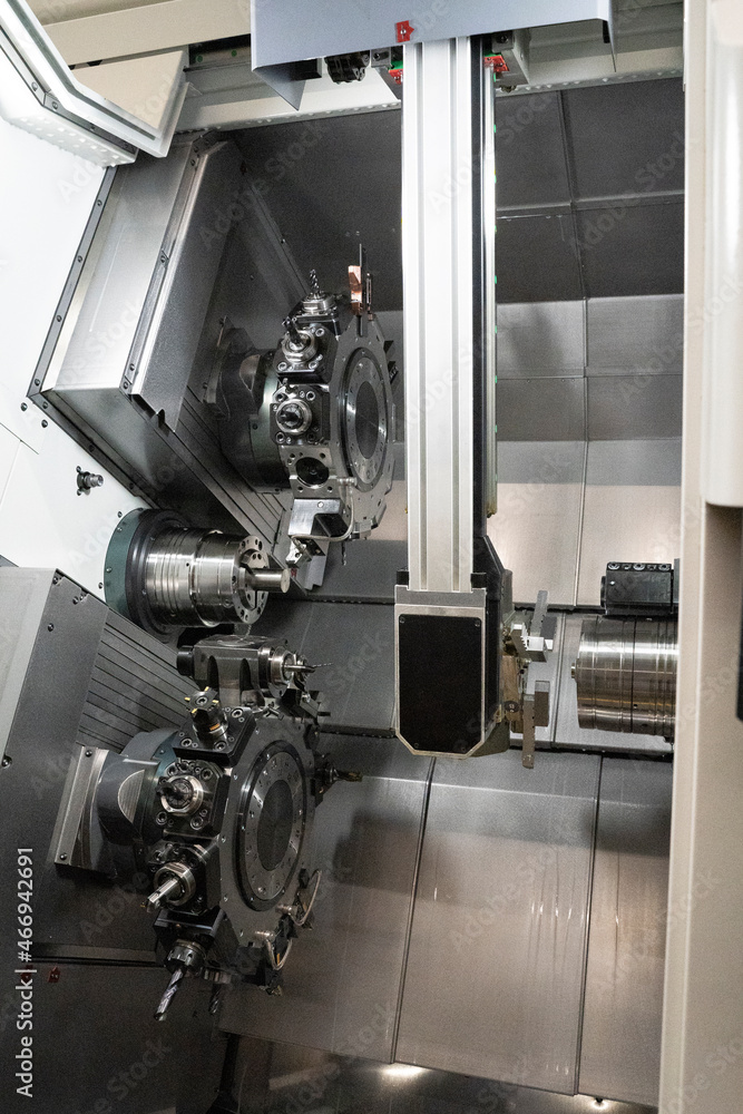 robotic arm working inside a cnc lathe robotic arm working inside a cnc lathe