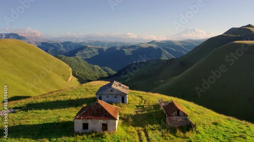 North Caucasus gorge in sunlight with abandoned houses. Aerial drone shot