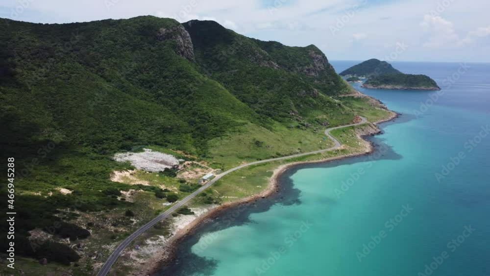 Establishing shot of the huge landfill located on a tropical island. A rubbish pile is in front of the most beautiful beach in the world. 
Coastal road divides this garbage lot from the sea. Vietnam