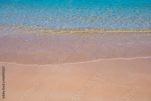 Beach background. Calm beautiful ocean wave on sandy beach. Sea view from tropical sea beach.